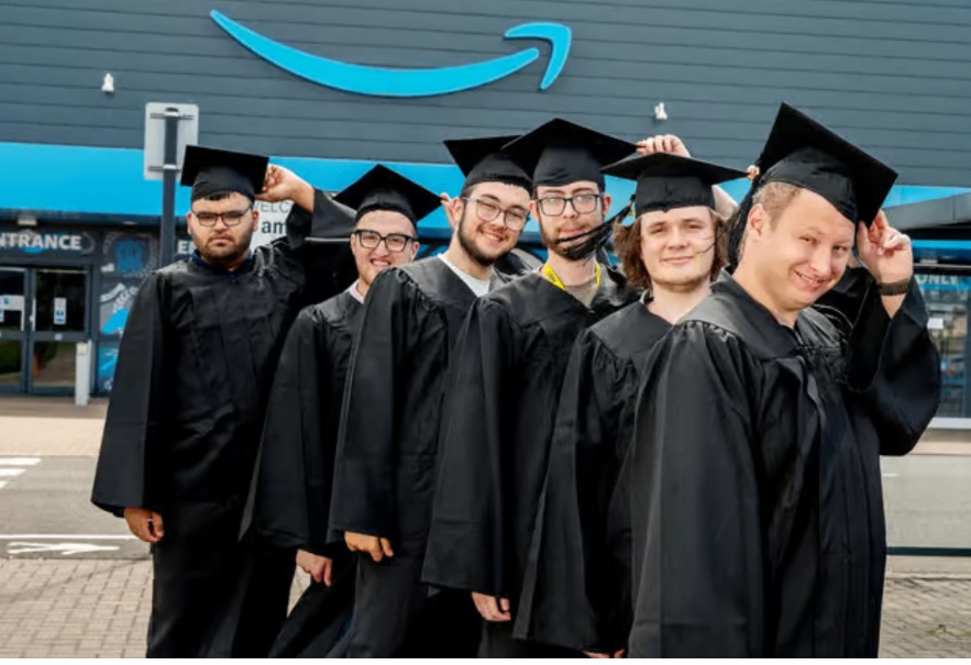 Six Aspirations Doncaster interns in graduation caps and gowns outside Amazon LBA4