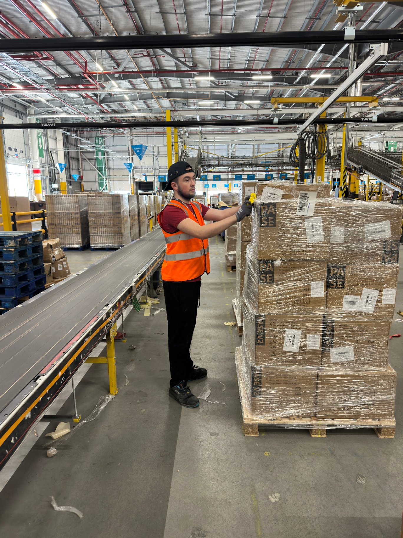Aspirations Doncaster intern wrapping and labelling a pallet at Amazon LBA4